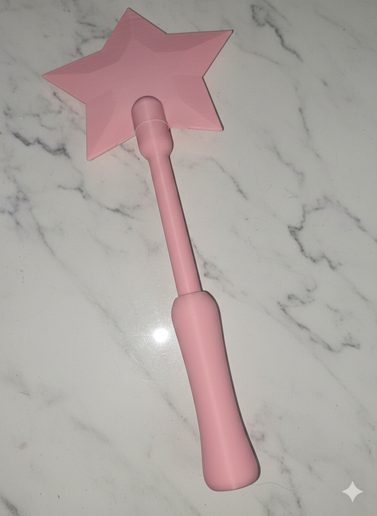 Pink star-shaped object on a marble surface. Tap and Pay Wand